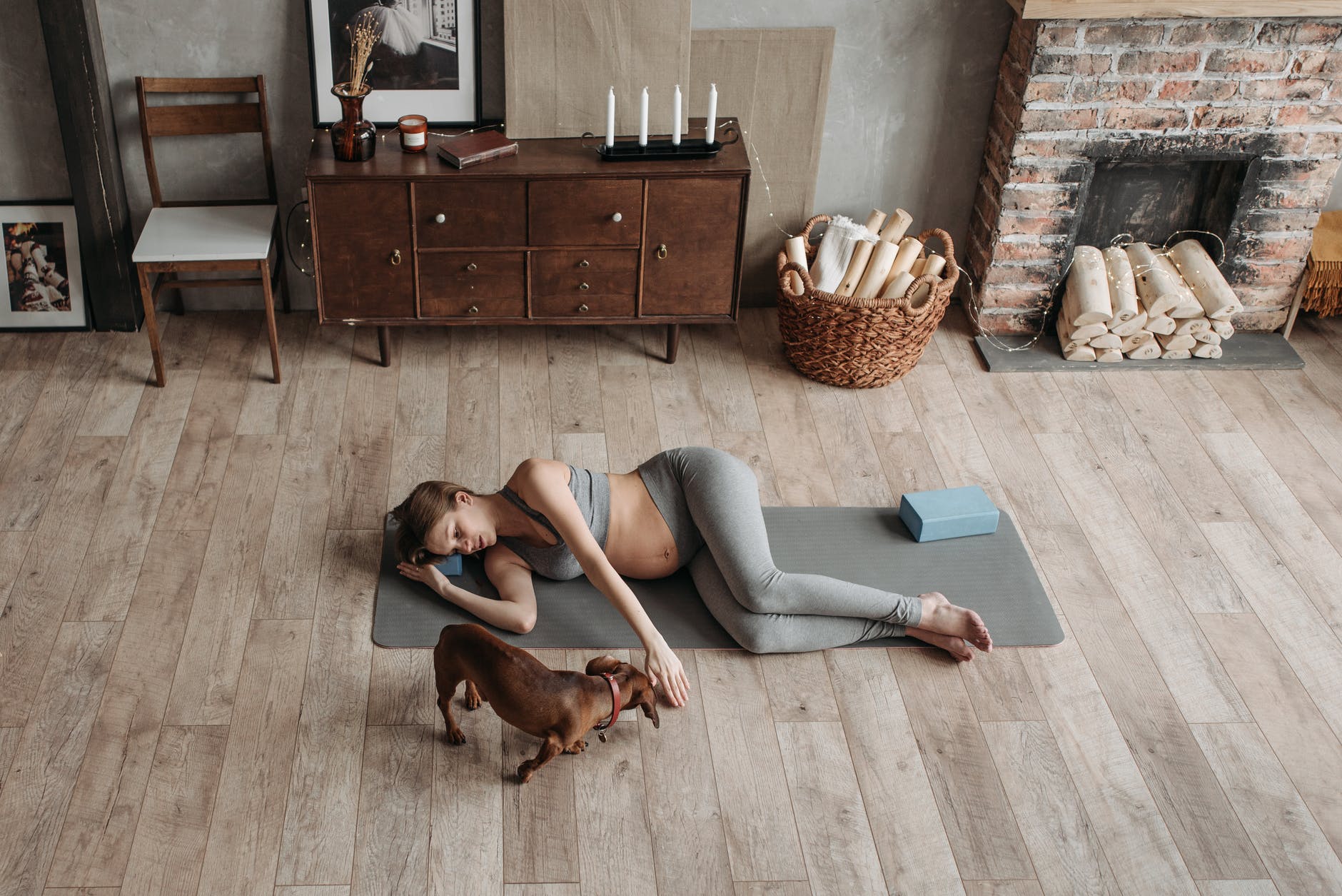 a pregnant woman lying down on a yoga mat